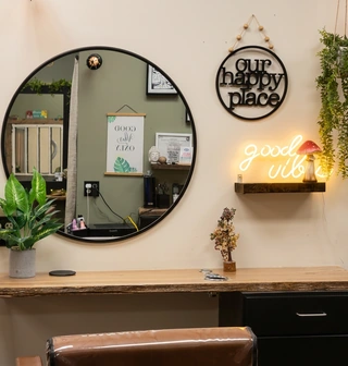 Good Vibes Salon mirror, plants and neon sign