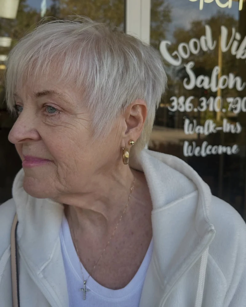 Short icy-blonde pixie haircut viewed from the side.