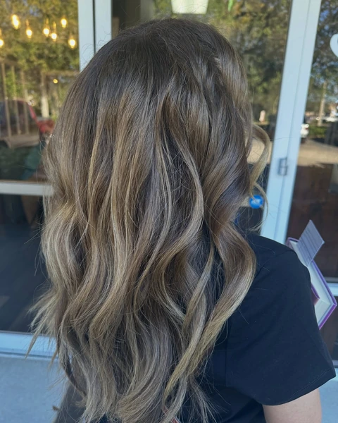 Dimensional brunette balayage with soft honey ribbons from crown through ends