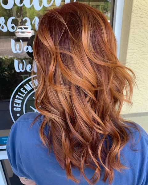 Glossy copper root and all-over color result shown from crown through styled ends