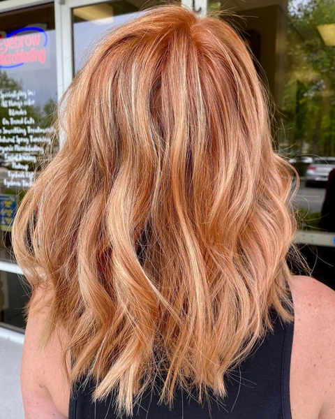 Copper layered lob haircut shown from the back with defined shape and styled movement