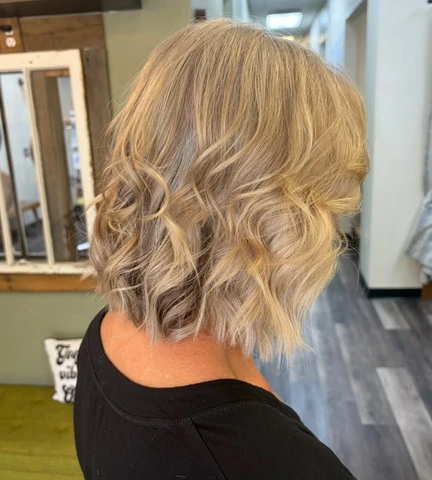 Short layered blonde bob with a polished curved finish and visible shape