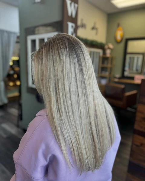 Long blonde hair with a visibly sleek smooth reflective salon finish
