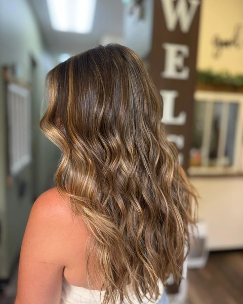 Glossy brunette salon waves with polished movement and shape
