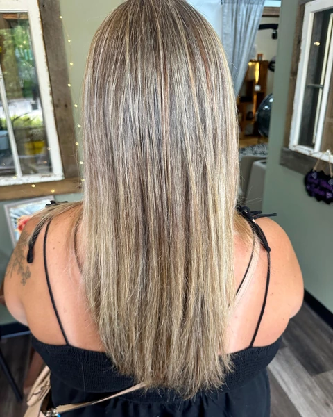 Straight sleek lob with reflective shine and a clean polished outline