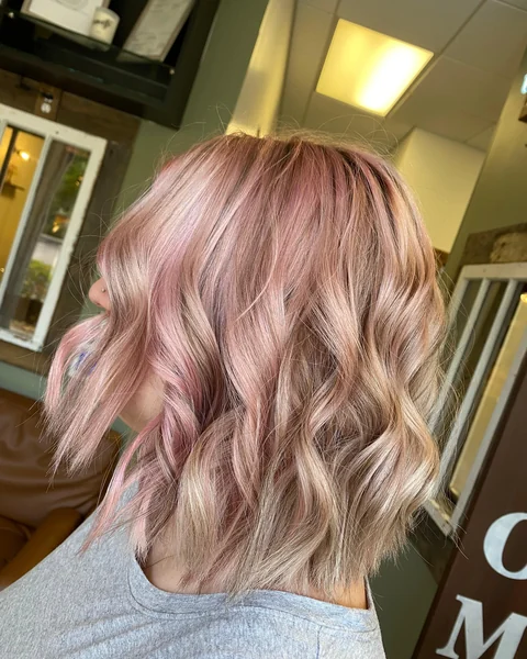 Modern pink lob haircut with visible shape movement and styled finish