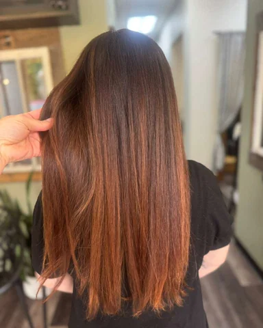 Long copper hair with sleek shine and controlled smooth finish