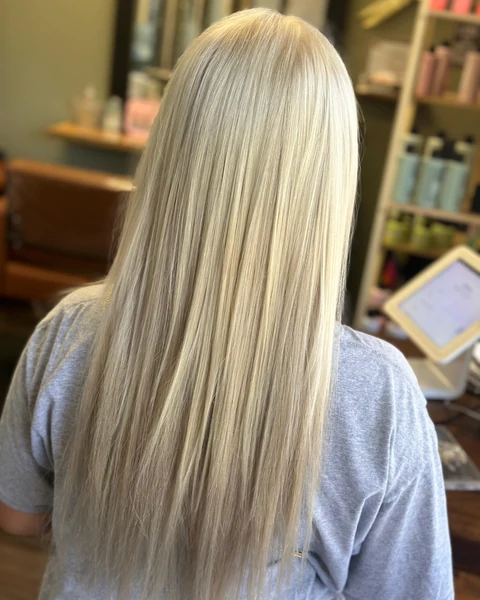 Salon client with bright neutral blonde hair and a smooth polished finish