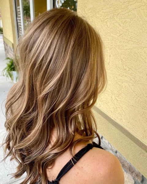 Salon client with a polished shoulder-length cut and styled shape