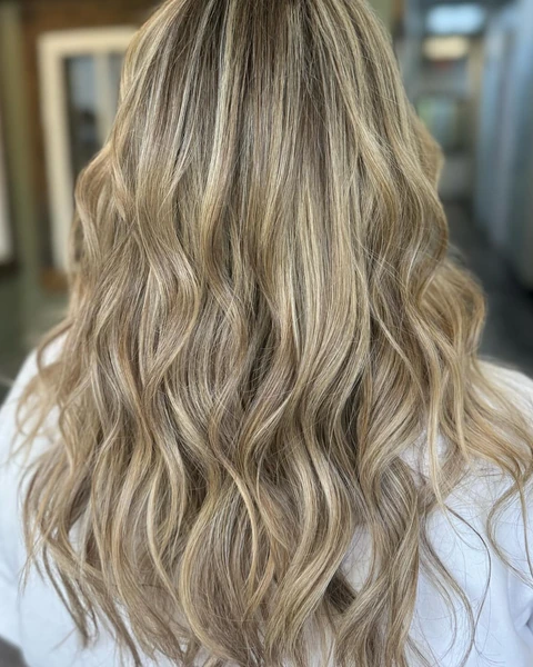 Bright dimensional blonde salon result photographed from the back
