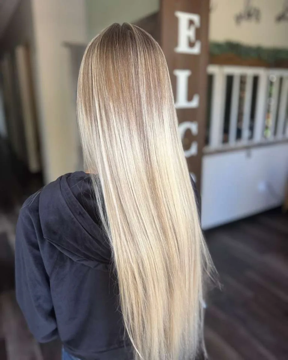 Salon-owned photograph of sleek blonde lengths, shown as finish inspiration.