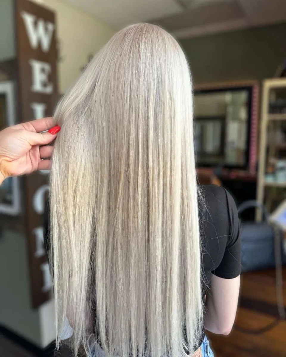 Salon-owned photograph of straight platinum-blonde lengths, shown as finish inspiration.