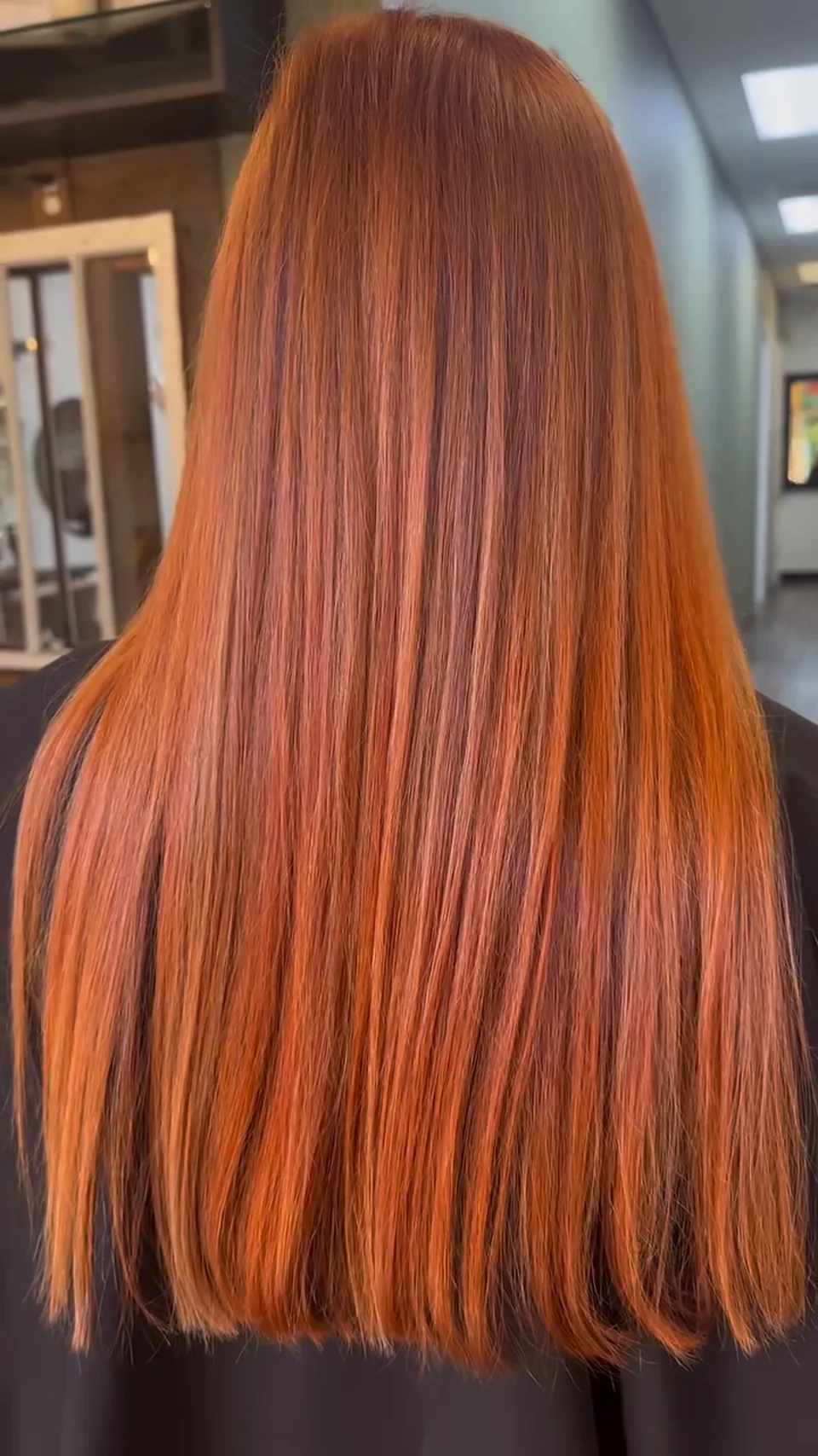 Salon-owned photograph of straight copper-toned lengths, shown as finish inspiration.